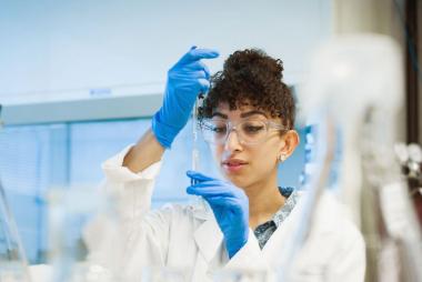 A student using a micropipette in the lab